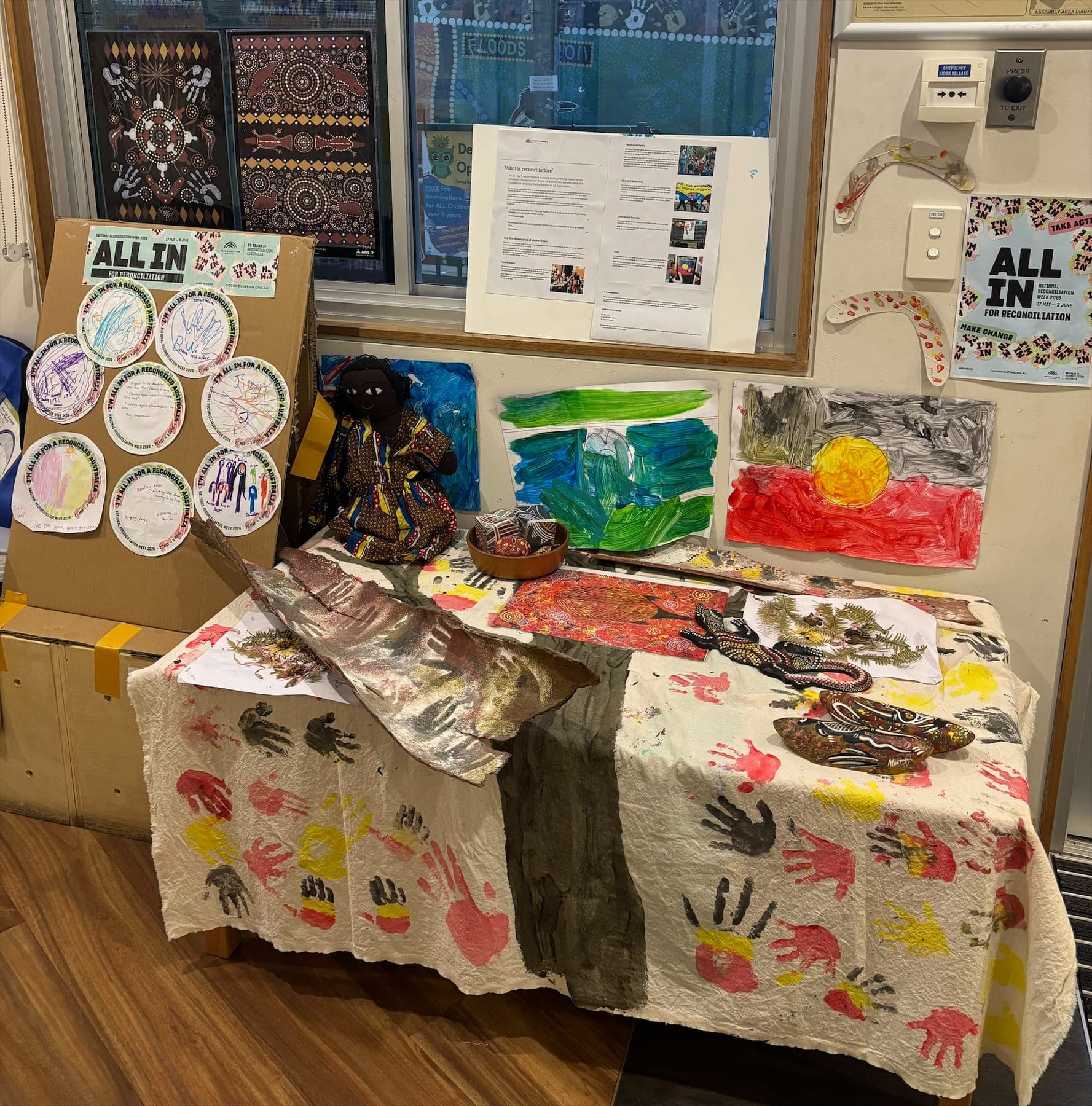 Children's reconciliation artwork and Aboriginal flag display in the centre